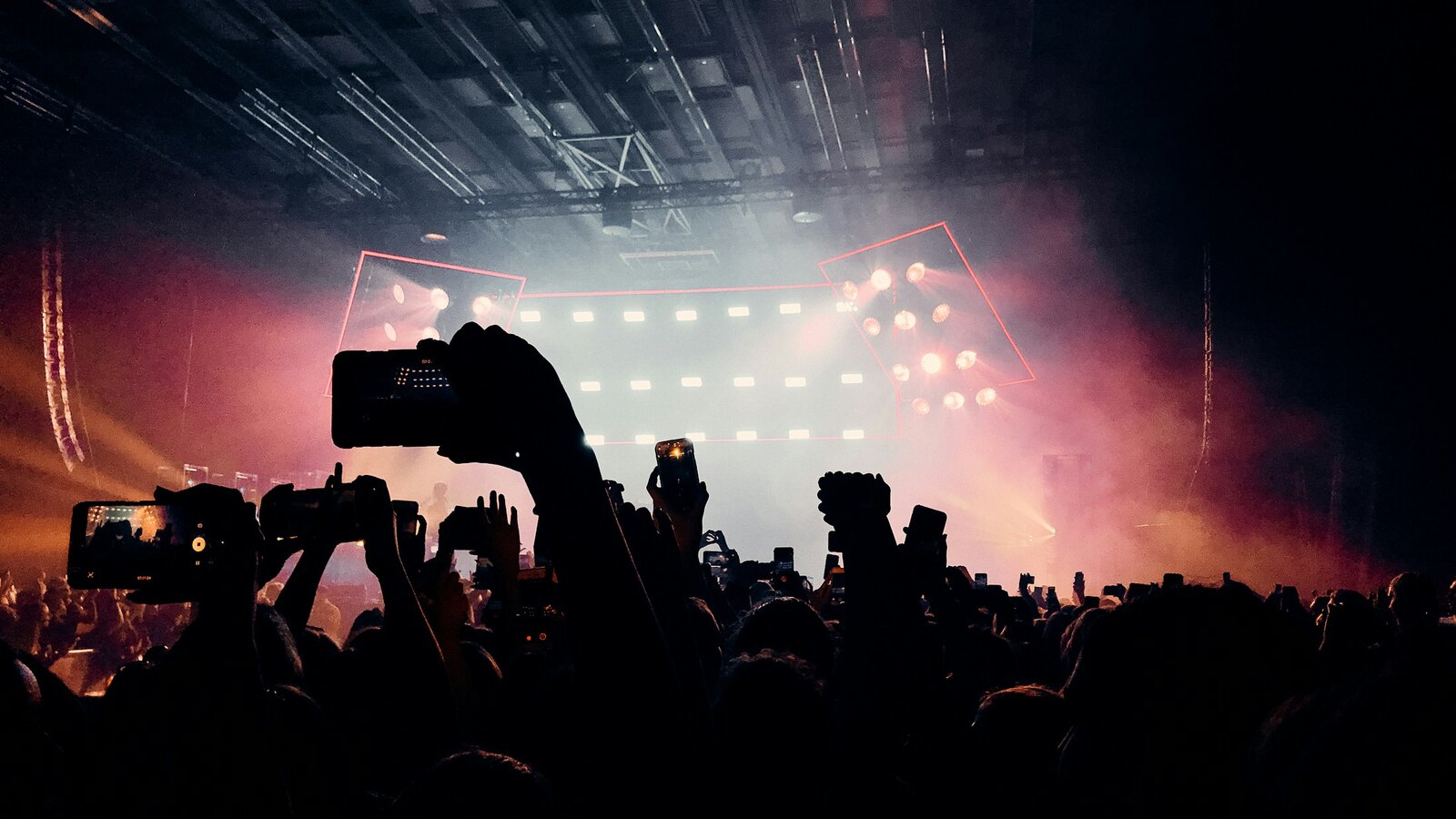 A crowd of fans under arena lights